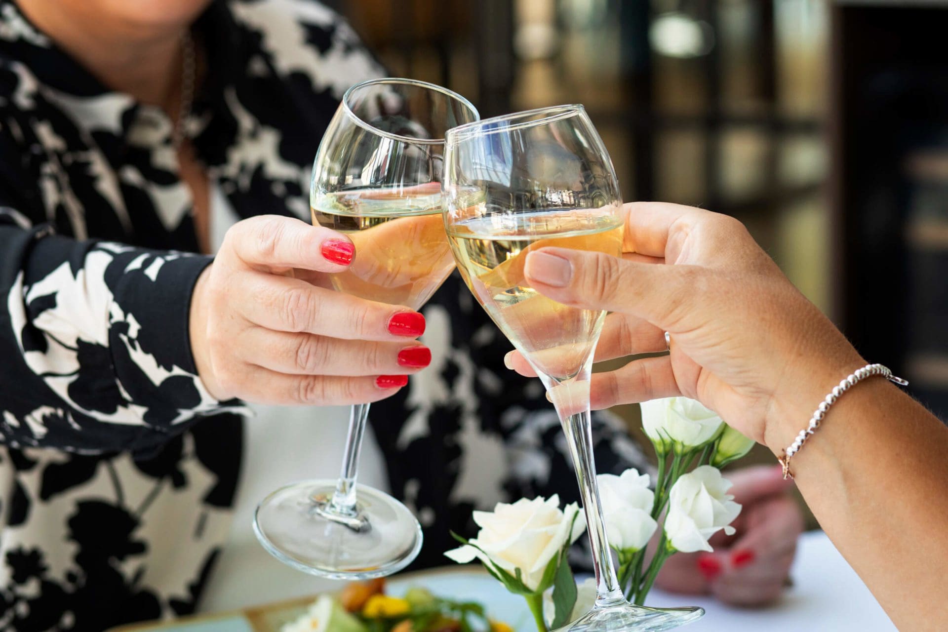 Image of 2 people toasting with wine